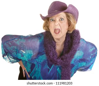 Angry senior woman in hat sticking out her tongue