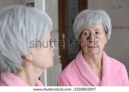Angry senior woman screaming in the mirror 