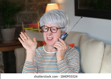 Angry Senior Woman Using Retro Style Landline Phone  