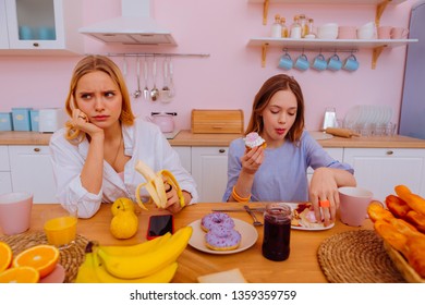 Angry Sister. Older Sister Feeling Angry While Teenage Sibling Eating Unhealthy And Sugary Food