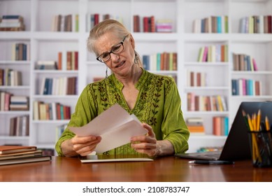 Angry Stressed Businesswoman Opening Envelope Reading Bad News In Mail Letter. Mad Female Feels Frustrated About High Bills, Dismissal Notice, Bank Debt, Tax Invoice Or Mistake At Home Office Library.