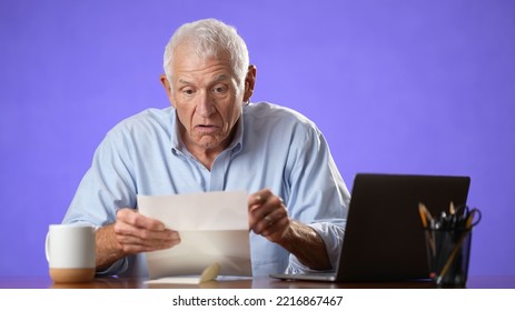 Angry Stressed Elderly Man 70s, Opening Envelope Reading Bad News In Mail Letter. Mad Man Feels Frustrated About High Bills, Bank Debt, Tax Invoice Or Mistake Isolated On Purple Background