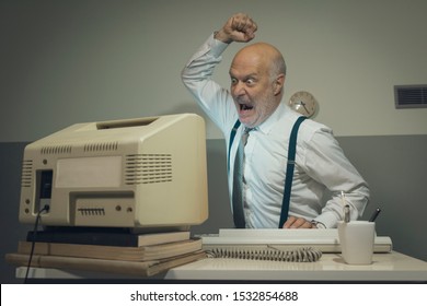 Angry Stressed Office Worker Hitting His Old Broken Computer