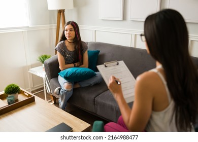 Angry Teen Girl Having A Negative Attitude During A Therapy Session With A Psychologist