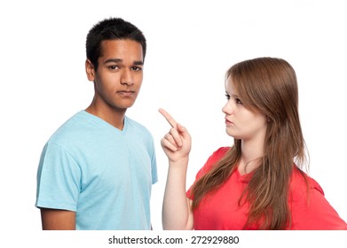Angry teenage girl with her boyfriend. Studio shot on white background.