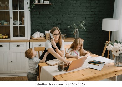 Angry and tired mother working with kids at home. Woman working, learns on laptop computer. Children playing, make noise, distract, disturb mom. Writing, typing. Technology concept. Maternity leave - Powered by Shutterstock