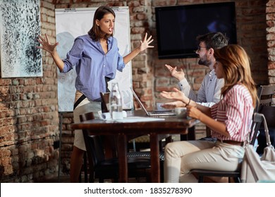 An Angry Waitress Shouting At Young Couple At A Cafe