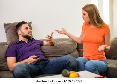 Angry Wife And Husband Are Having Conflict Because Husband Is Watching Tv Too Much.