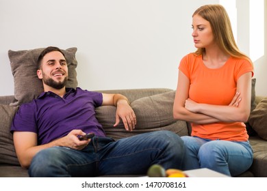 Angry Wife And Husband Are Having Conflict Because Husband Is Watching Tv Too Much.