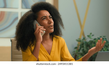 Angry woman African American businesswoman girl female employer boss arguing smartphone call annoyed stressed business lady mad negative conversation conflict quarrel talking mobile phone in office - Powered by Shutterstock