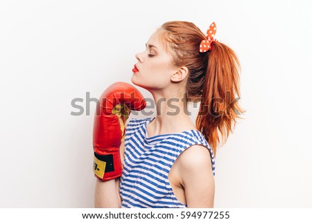 angry woman in boxing gloves on a white background