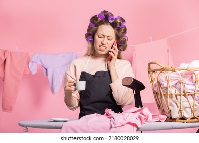 The Angry Woman Clenches Her Teeth In Exasperation. A Phone Call Interferes With Her Coffee, Getting Ready For Work, Ironing Clothes.