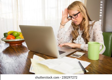Angry woman doing her taxes at home