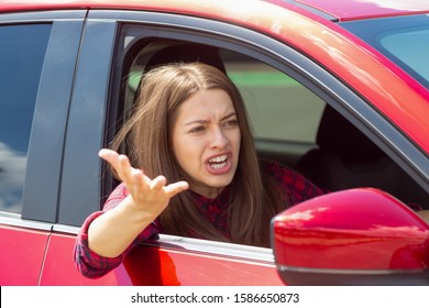Angry woman driver screaming in the car. The quarrel and dissatisfaction on the way.