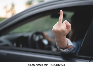 Angry Woman Driver Shows An Obscene Gesture A Middle Finger Through The Window.