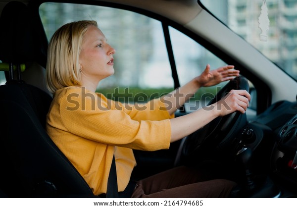 Angry woman driving a\
car