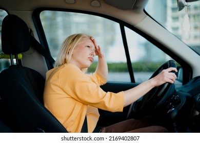 Angry Woman Driving A Car. Upset Young Woman Driving Car In City