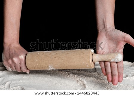 Angry woman hands with rolling pin above flour. Baking concept.