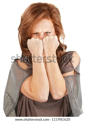 Angry woman hiding her face behind fists