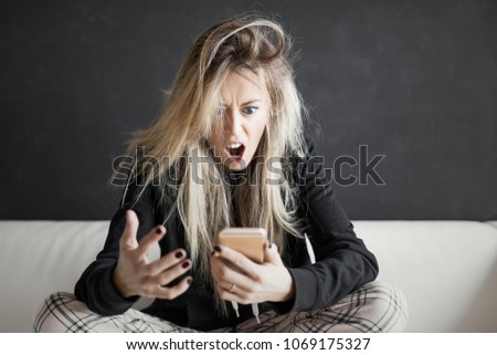 Angry woman looking at phone