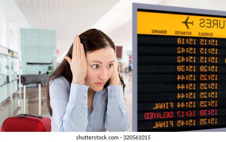 angry woman pulling with  her hands on temple because she has missed the flight