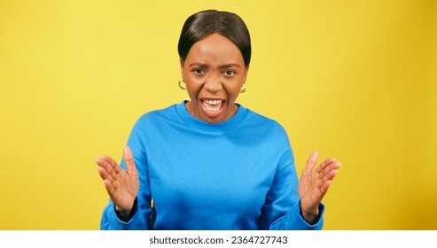 Angry woman scolds and yells, shouting with hand gestures, yellow studio - Shutterstock ID 2364727743