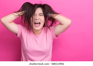 Angry woman screaming out and pulling her hair