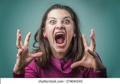 Angry woman screaming with rage, furious and dangerous - Shutterstock ID 574045543