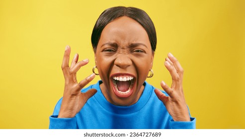 Angry woman screams and yells with hand gestures, yellow studio - Shutterstock ID 2364727689