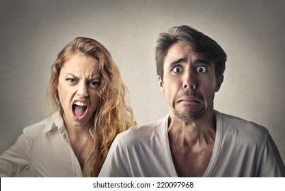 Angry woman shouting and fearful man 
