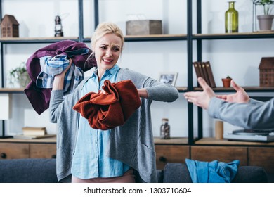 Angry Woman Throwing Clothes In Living Room After Breaking Up With Boyfriend