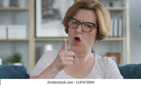 Angry Yelling Old Woman Reacting To Problem At Work