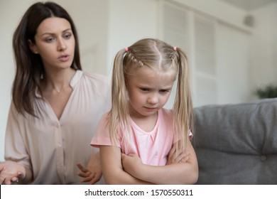 Angry Young Adult Mom Scold Stubborn Fussy Upset Little Kid Daughter Sulking Sit On Sofa Ignore Parent, Single Mother Shout At Unhappy Preschool Difficult Child Girl Punish For Bad Behavior At Home