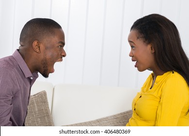 Angry Young African Man Screaming At Woman