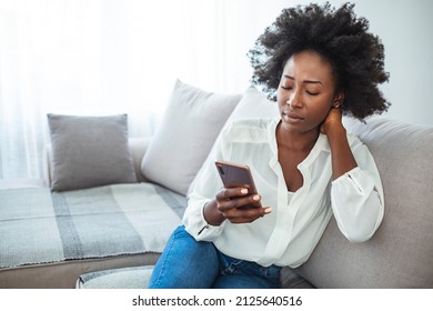 Angry Young African Woman Looking At Smartphone, Frustrated With No Signal Or Message Of Deception, Crazy Woman Disappointed Reading Bad News On Phone, Upset Girl Gets Negative Answer