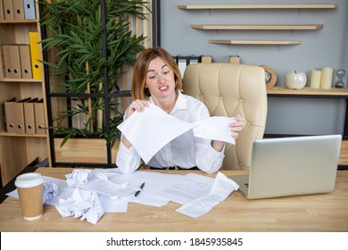 Angry Young Business Woman Tearing Up Documents In The Office