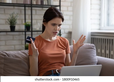 Angry young Caucasian woman look at laptop screen feel frustrated confused have payment problem on gadget, unhappy millennial distressed with internet system failure shopping paying on web