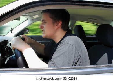 Angry Young Male Driver Speeding Very Fast Showing Anger As Roadrage