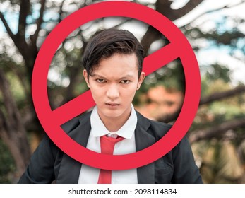 An angry young man after being called out or ostracized in social media or in person. Cancel culture concept. With stop sign graphic. - Shutterstock ID 2098114834