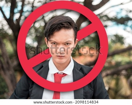 An angry young man after being called out or ostracized in social media or in person. Cancel culture concept. With stop sign graphic. Stock photo © 