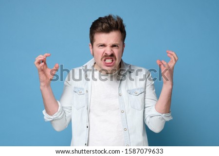 Angry young man has grumpy expression having quarrel with wife. Negative human emotions.