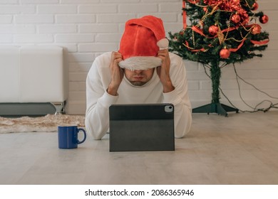 Angry Young Man Shopping At Home At Christmas Online