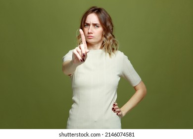 Angry young woman does warning gesture with raised finger, forbid something. Don't do this, be careful. Prohibition sign - Shutterstock ID 2146074581