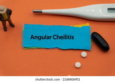 Angular Cheilitis.The word is written on a slip of colored paper. health terms, health care words, medical terminology. wellness Buzzwords. disease acronyms.
