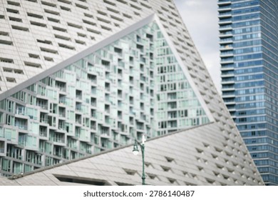 Angular Glass Facade Framed By Skyscrapers Showcasing Repetitive Balcony Patterns, new york