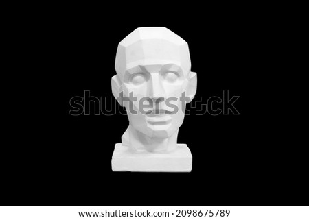angular plaster man head isolated on black background. High quality photo