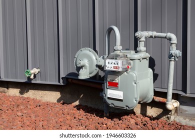 An angular view of a residential gas meter and pressure regulator mounted on the exterior of the home
