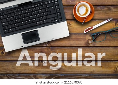 Angular web framework.. Word Angular on wooden desk with laptop