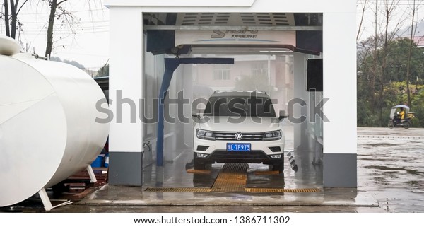 Anhui, Asia, China, December 10, 2018: The\
driver who came to the car to drive the car into the automatic\
cleaning machine for\
cleaning