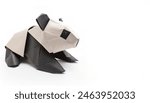Animal concept origami isolated on white background of black and white panda bear - Ailuropoda melanoleuca, with copy space, simple starter craft for kids